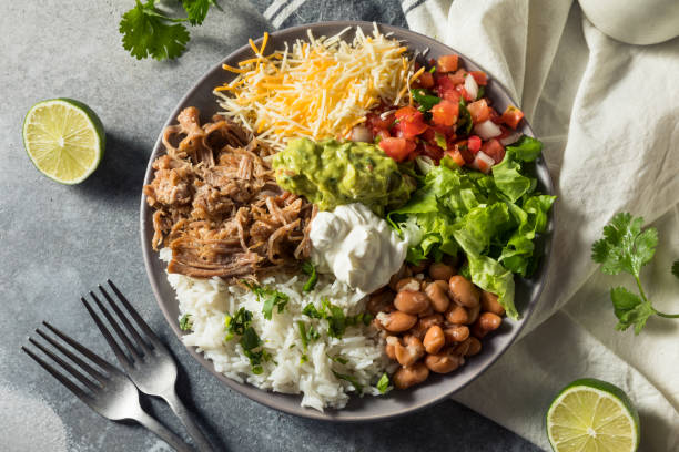 healthy homemade mexican carnitas burrito bowl cilantro and guacamole